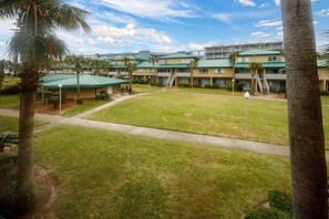 A hotel with multiple buildings, a central courtyard, and palm trees.