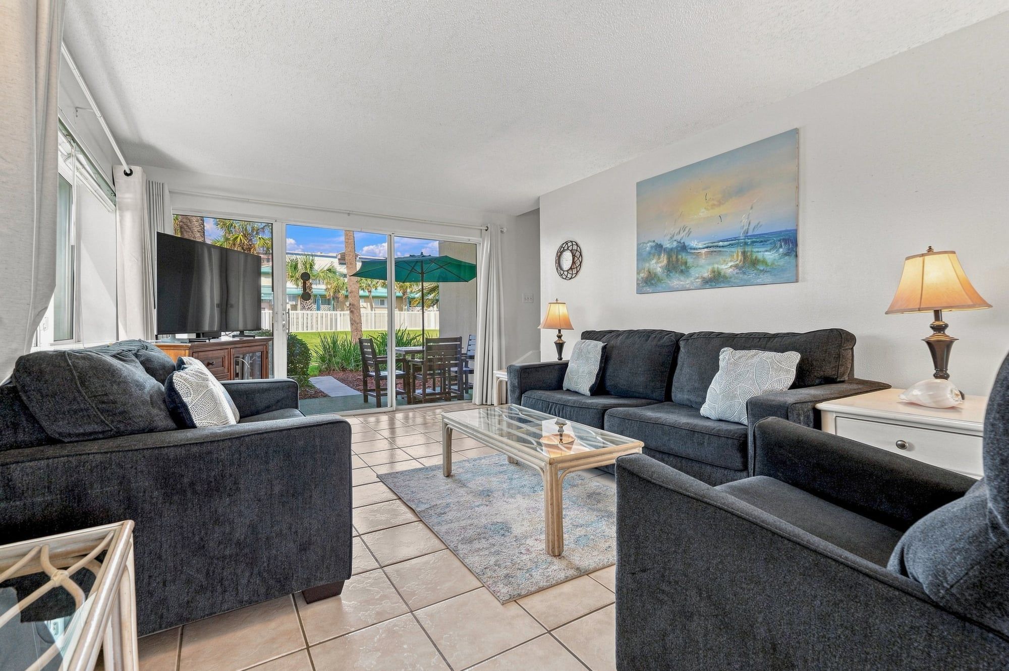 A living room with a sofa set, a coffee table, and a TV.