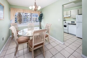 Cozy dining area with a round table and four chairs, perfect for casual gatherings.