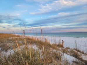 A beach with sand dunes and sparse vegetation. - Seaspray Condos - 210C (Fort Walton Beach)