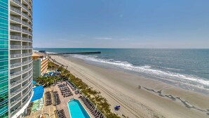 A beachfront hotel with a pool, beach access, and a pier. - · Beautiful Oceanfront Deluxe - Pool, Lazy River, Hot Tub and more! (Myrtle Beach)