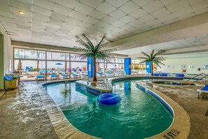 Relax by the pool surrounded by lounge chairs and umbrellas.
