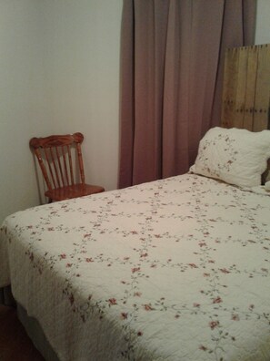 Cozy retreat with a single bed and comfortable seating area.