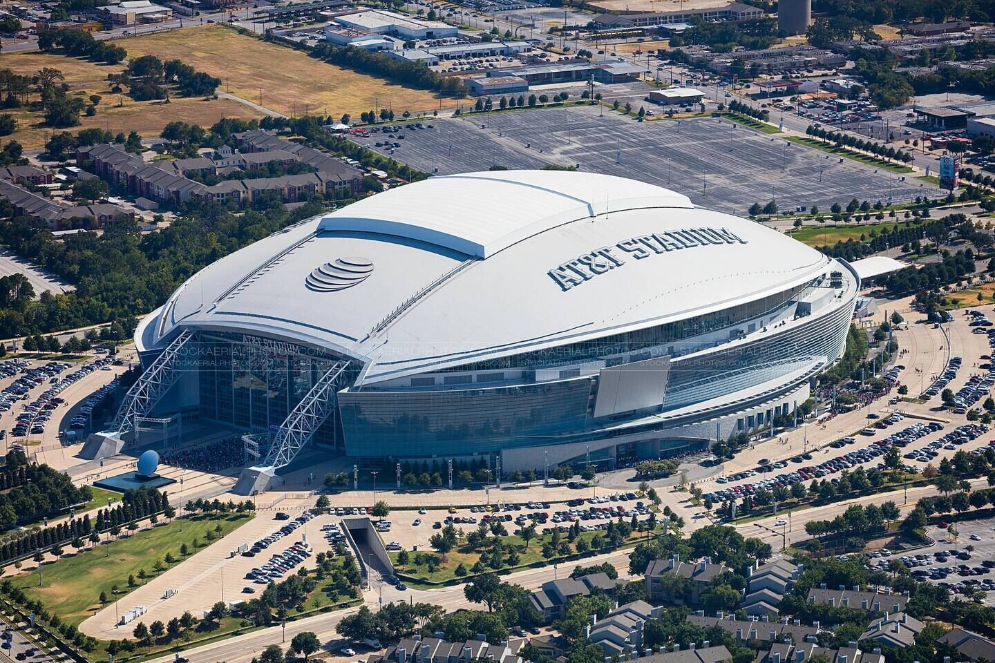 A large stadium with a distinctive curved roof and multiple levels of seating.