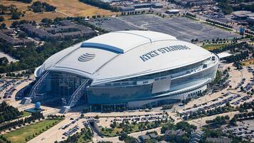 A large stadium with a distinctive curved roof and multiple levels of seating.
