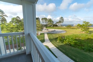 Enjoy a serene view of the well-maintained lawn and garden from your balcony.