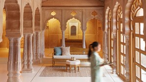 A spacious interior with high ceilings, ornate arches, and a central seating area. - Six Senses Fort Barwara (Chauth Ka Barwara)