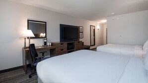 A hotel room with a large bed, a desk with a computer, a television, and a lamp. - Comfort Inn & Suites (Carleton Place)
