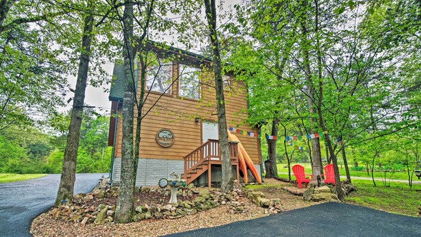 A cabin with a wooden exterior, a staircase, and a slide leading to a deck. - Bright Lakeside Studio - Hike, Fish, and Bike! (Golden)