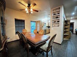 Enjoy meals in this dining area with a large table and comfortable chairs.