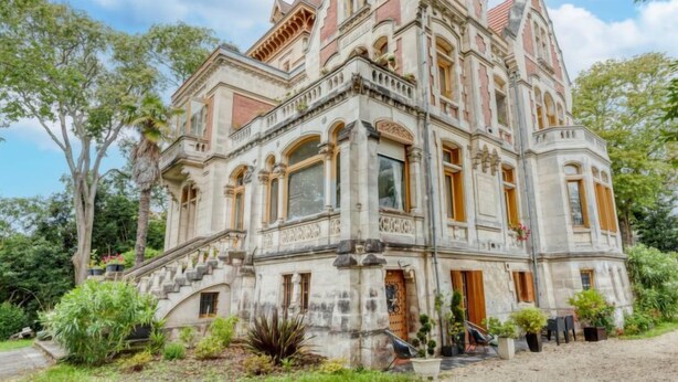 A large, ornate building with multiple levels, a prominent staircase, and a well-maintained garden. - Villa Giroflé by Interhome (Arcachon)