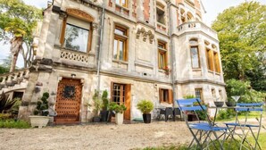 A historic building with a large wooden door, multiple windows, and a balcony. - Villa Giroflé by Interhome (Arcachon)
