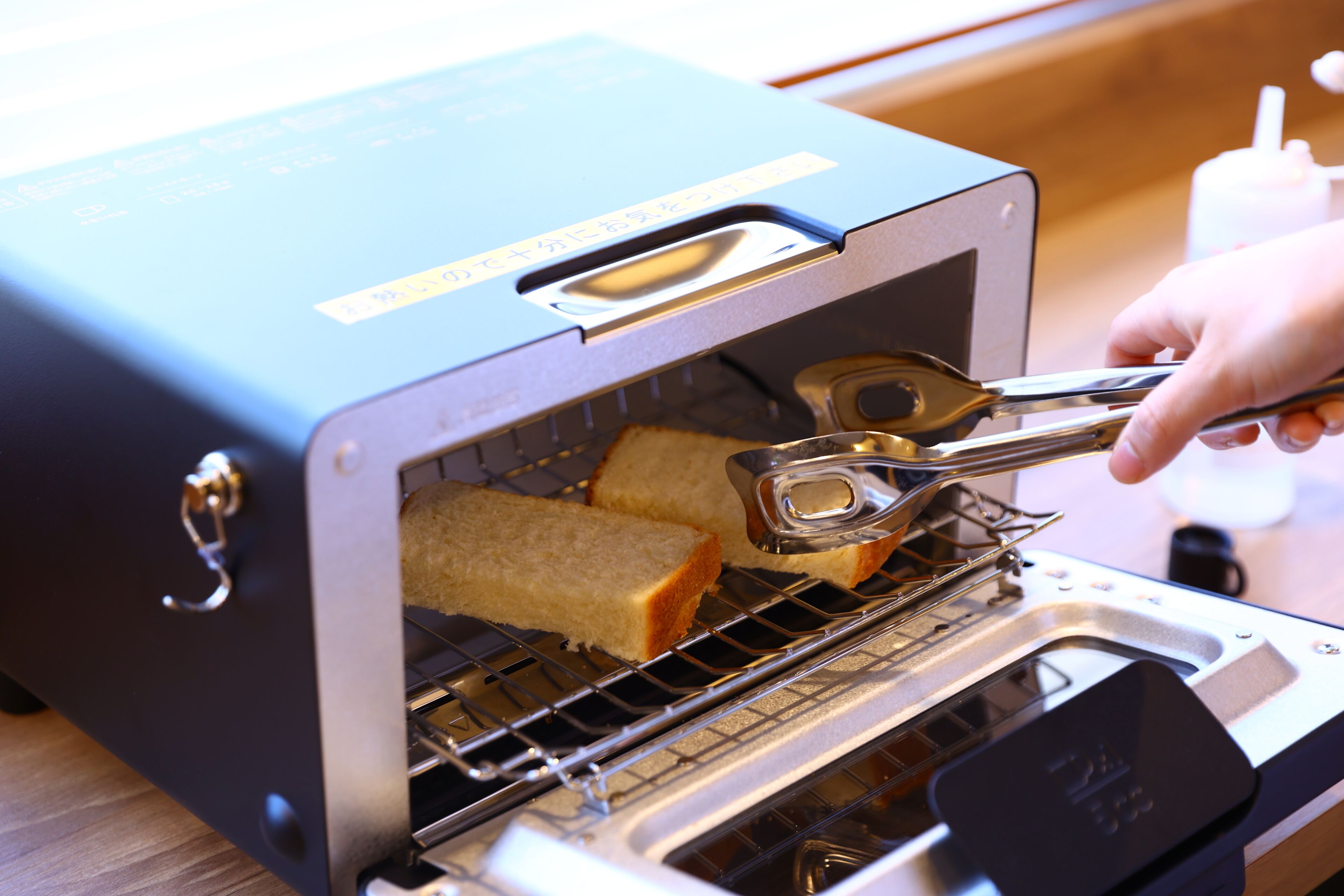 A toaster oven with two slices of bread inside.