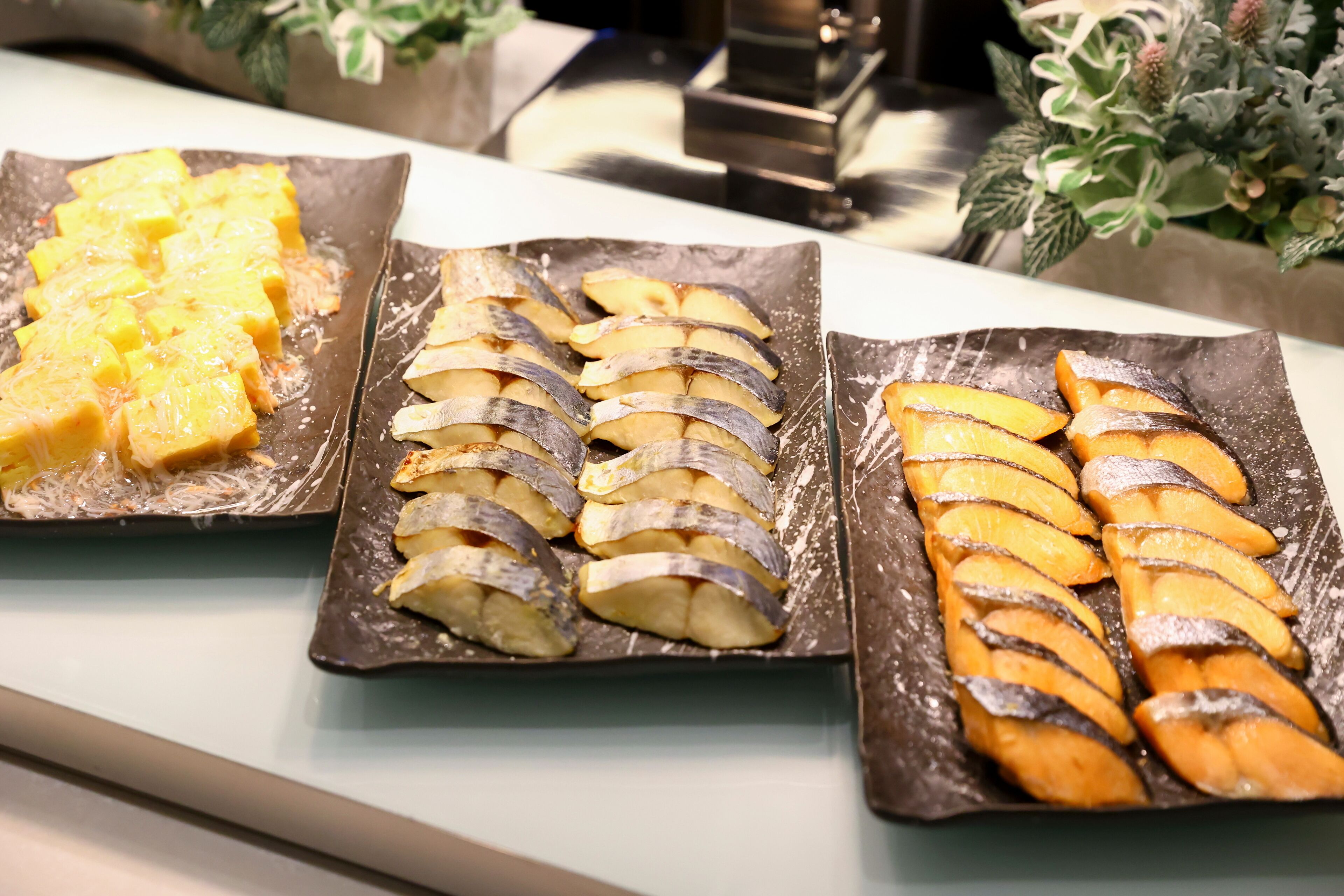 Three plates of food with different fruit arrangements.