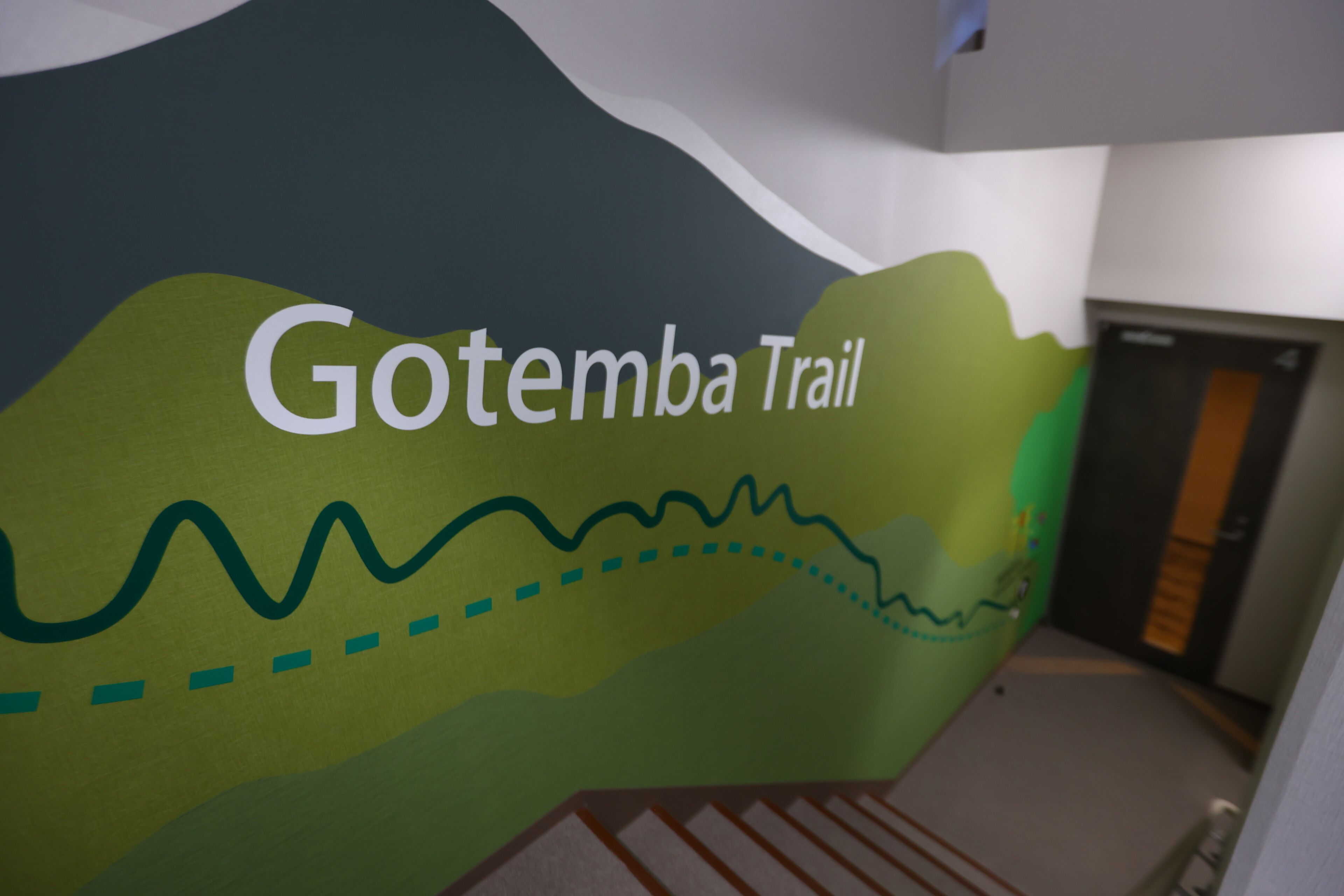 A wall with the text "Gotemba Trail" and a simple line drawing of a hilly landscape.