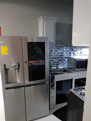 Microwave, stovetop, coffee/tea maker, cookware/dishes/utensils