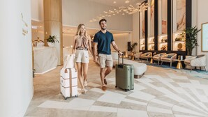 Una hall moderna con pavimento a scacchi, una reception e zone relax.