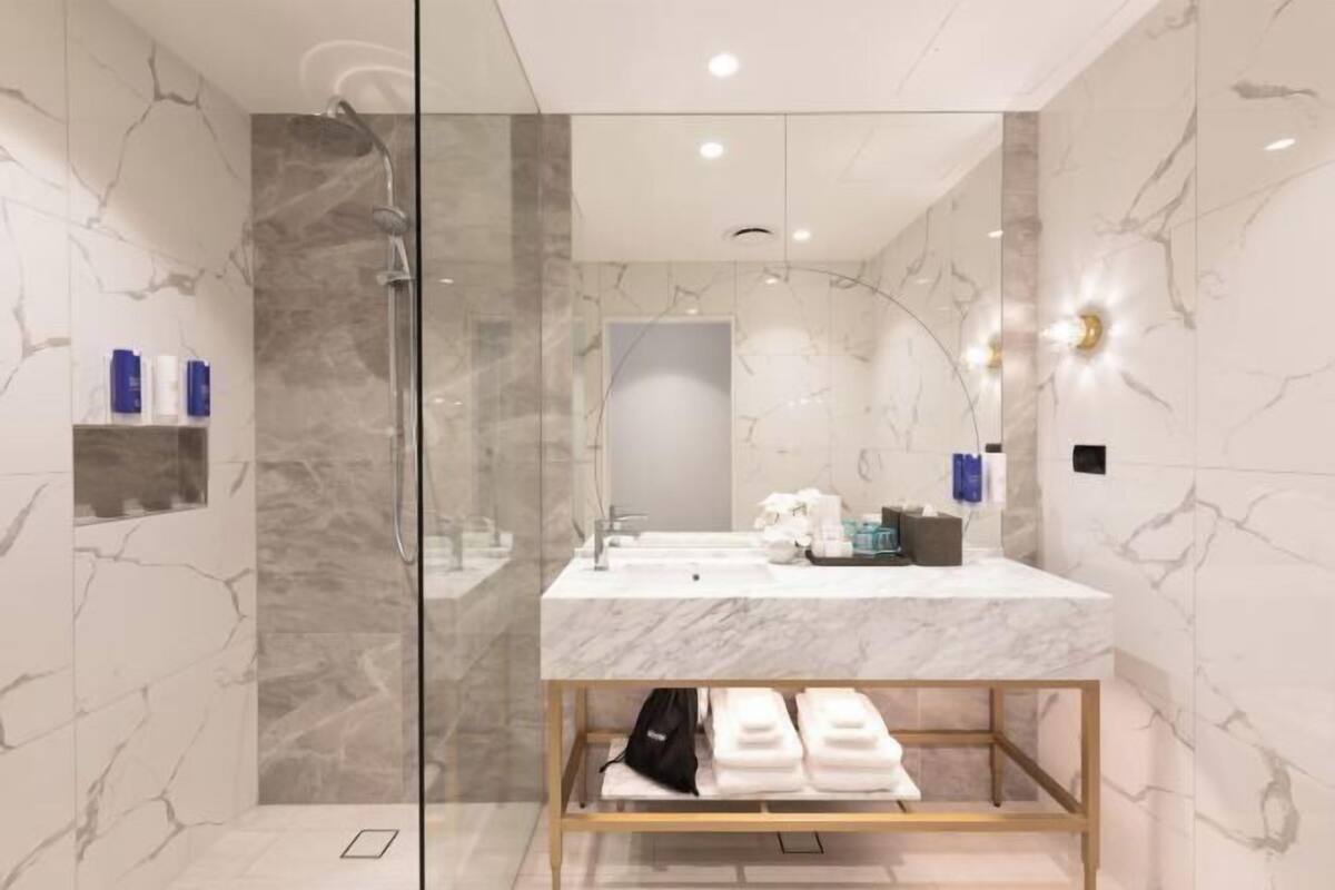 Shower, rainfall showerhead, designer toiletries, hair dryer