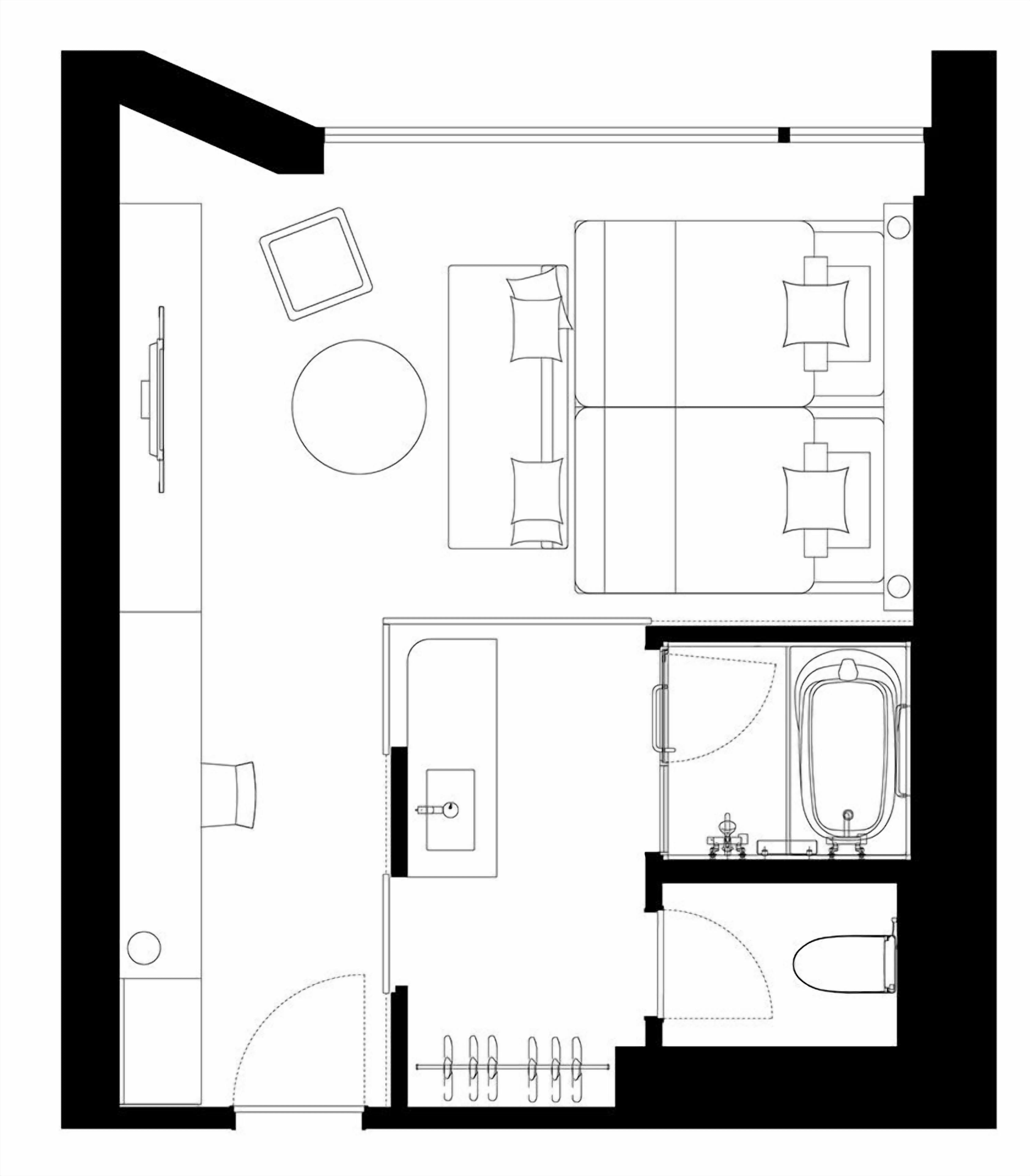 Pianta della camera d'albergo con un letto, una scrivania, una sedia, un tavolino, un tavolo rotondo, un divano e un bagno con vasca, doccia e WC.