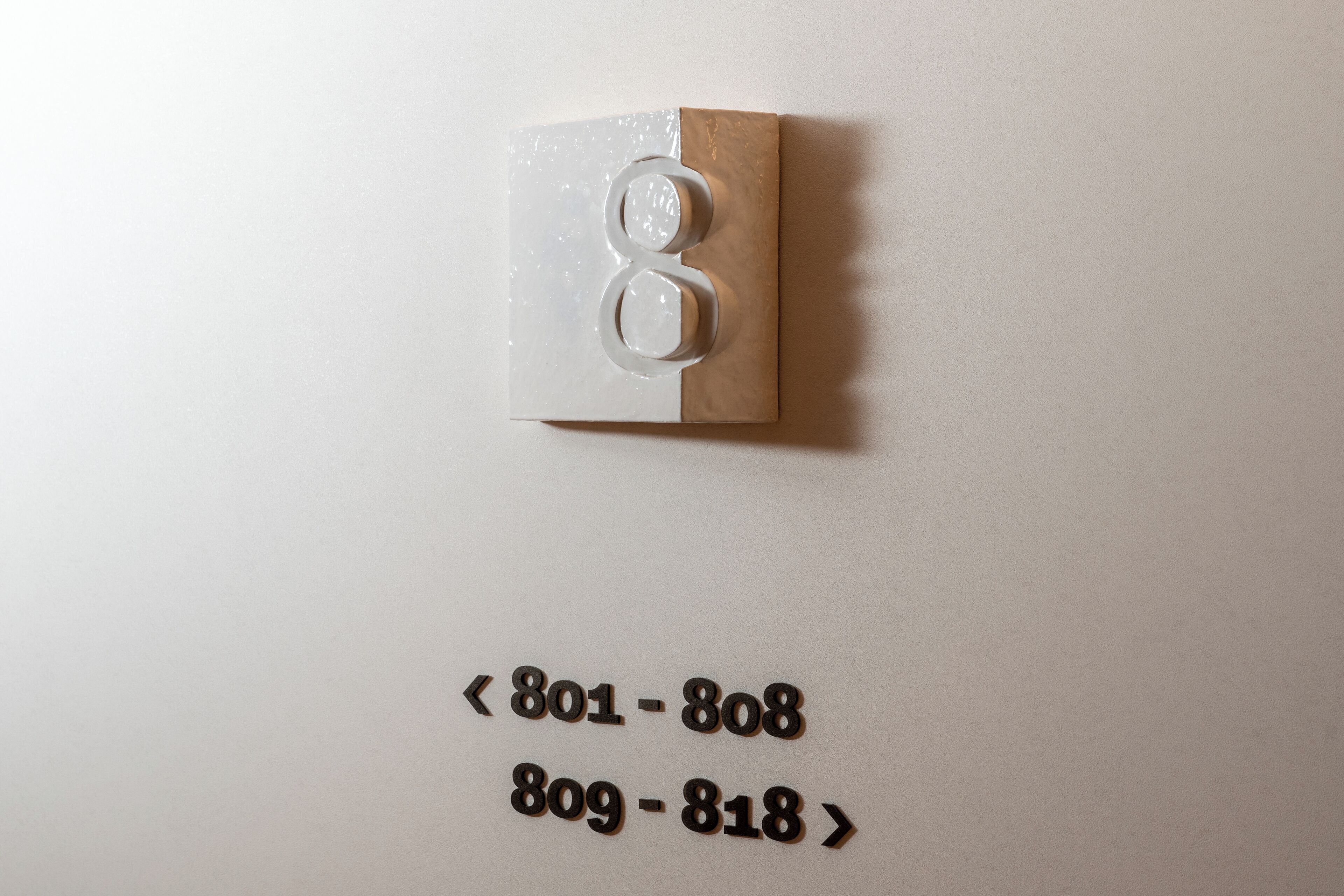 A wall-mounted light switch with numbers 801-808 and 809-818 visible below it.