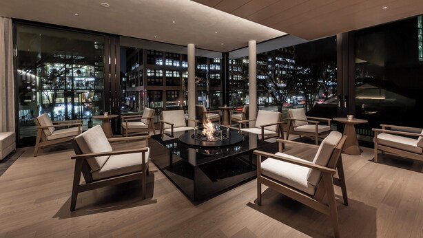 A modern lounge area with a central fire feature, comfortable seating, and large windows offering city views. - The Royal Park Hotel Iconic Kyoto (Kyoto)