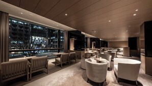 A modern lounge area with seating, large windows, and a view of the cityscape. - The Royal Park Hotel Iconic Kyoto (Kyoto)