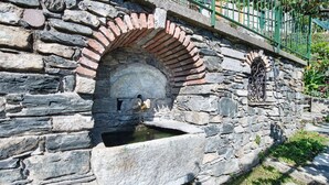 A stone structure with a brick archway and a water feature. - Vacation Apartment in Beautiful Vineyard 'Crotto Palma' with Lake View & Wi-Fi (Dongo)