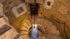A spiral staircase with stone walls and a chain mechanism. - Pet-Friendly Vacation Home Moli Den Barret with Mountain View, Pool & Wi-Fi (Santa Margalida)