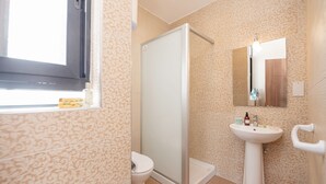 A bathroom with a toilet, shower, and sink. - GetawaysMalta - Harbour Lights Seafront Penthouse with Terrace St Paul's Bay (St Paul's Bay)