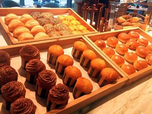 A variety of baked goods displayed in wooden trays. - Courtyard by Marriott Jiangyin (Wuxi)