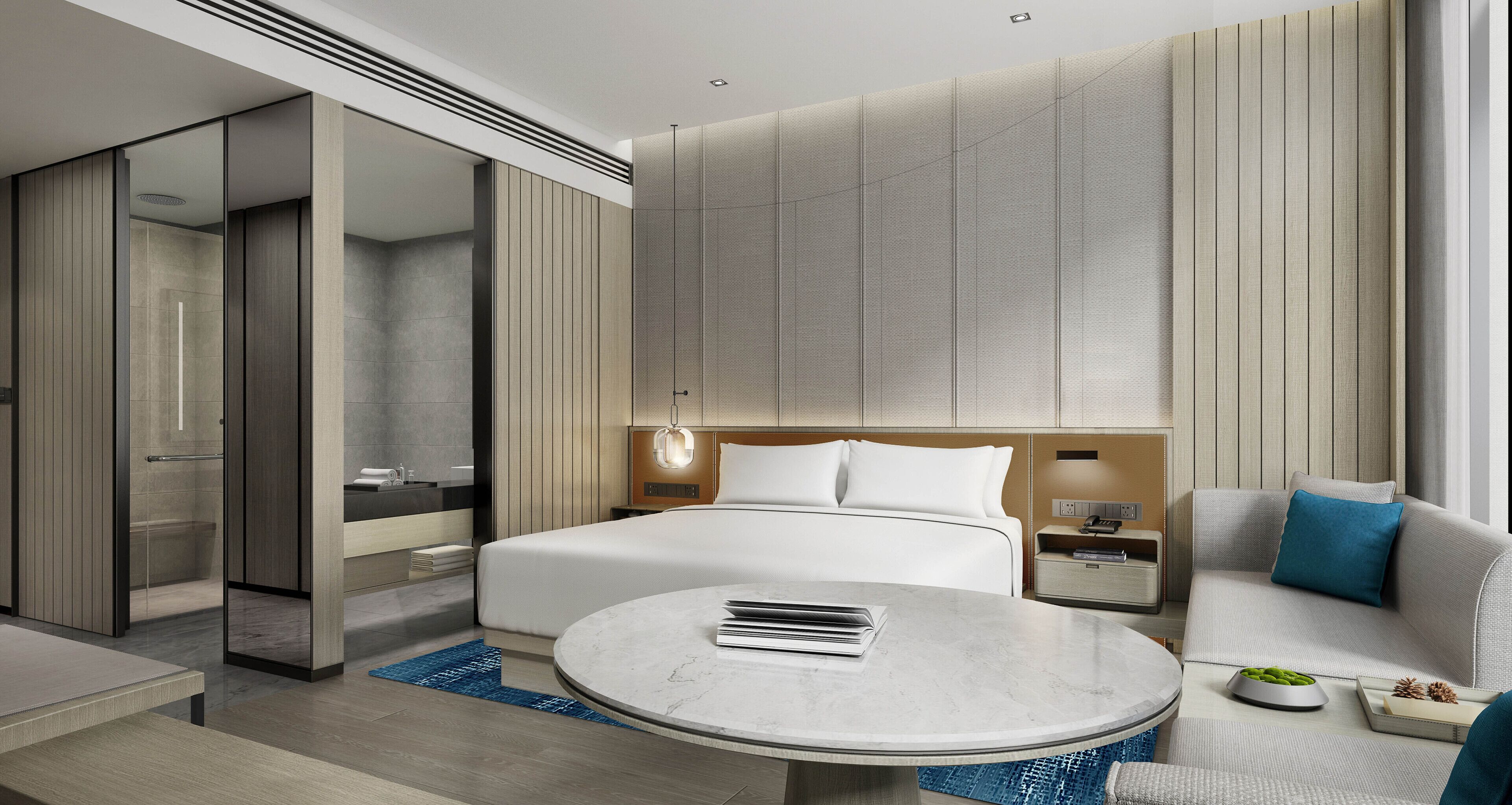 Una habitación de hotel moderna con una cama grande, una mesa redonda, un sofá y un vestidor.