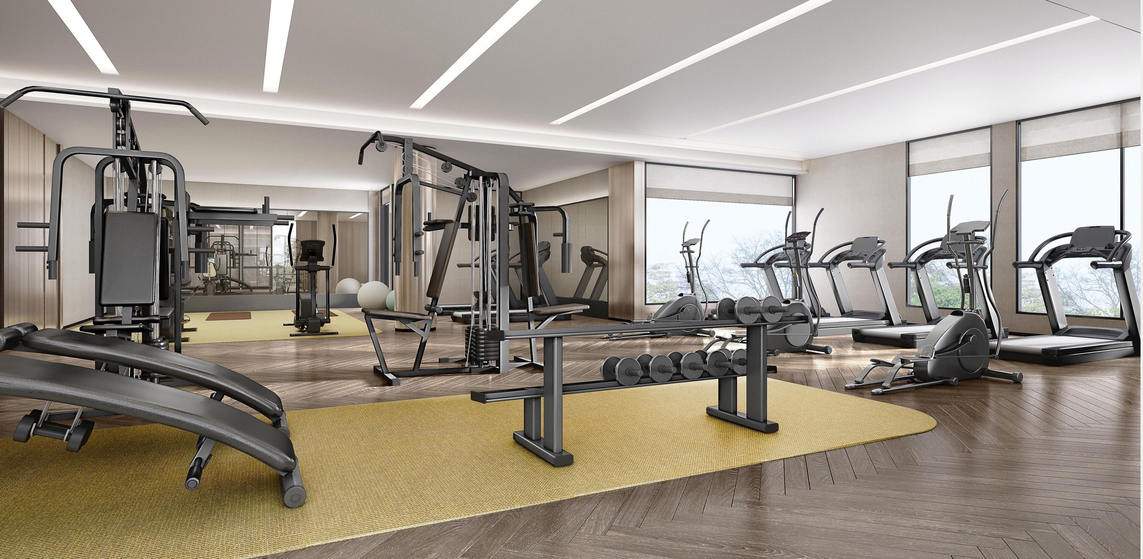 Ein modernes Fitnessstudio mit Laufbändern, Gewichten und einem großen Spiegel.