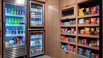 A vending area with multiple beverage dispensers and snack shelves.