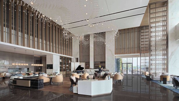 A spacious lobby with a central seating area, a piano, and a bar. - Yancheng Marriott Hotel (Yancheng)