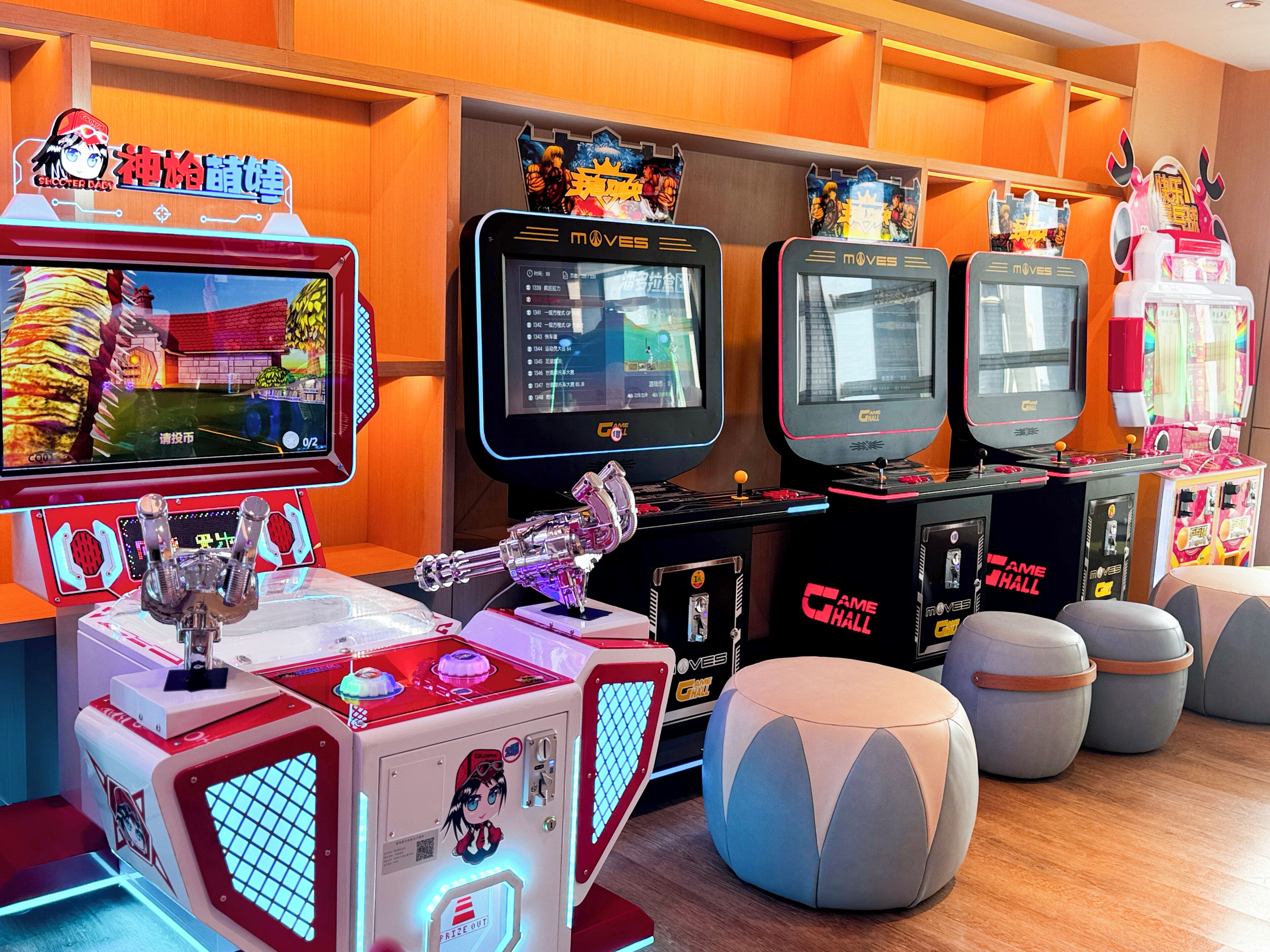 A gaming arcade with multiple arcade machines, including a claw machine and a racing game.