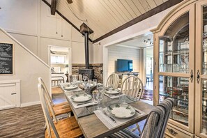 Enjoy meals in this inviting dining area with a long table and comfortable seating.