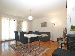 A modern living room with a dining table, sofa, and floor lamp. - Apartment 2078/34773 (Istria - Peroj), 750m from the beach (Peroj)