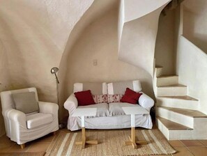 Relax in this stylish room with a comfortable sofa, armchair, and small table, perfect for unwinding.