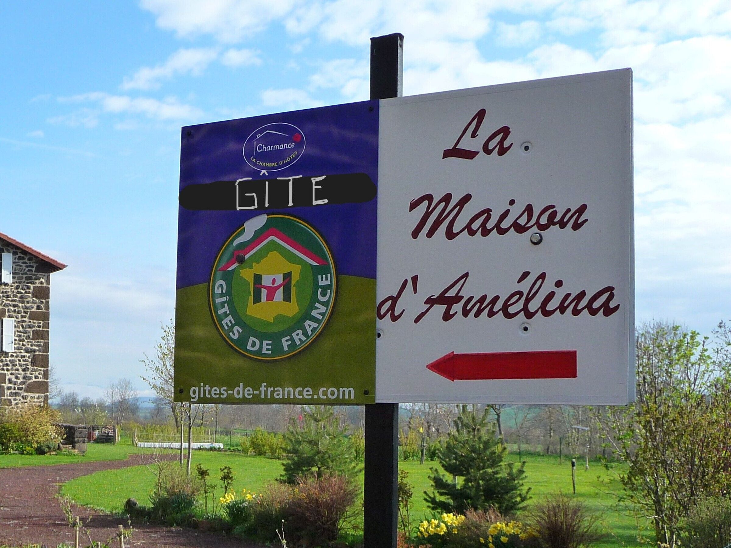 A sign for Gites de France, indicating a location named La Maison d'Amélina.
