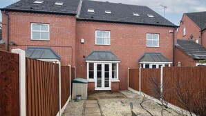 A residential brick house with a fenced backyard, a shed, and a clear sky. - Fantastic 4 bed house with 3 bathrooms in pleasant location (West Bromwich)