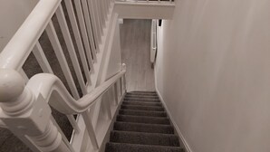 A staircase with white railings and carpeted steps. - Amy's Place Charming 3 Bed House Donegal (Stranorlar)