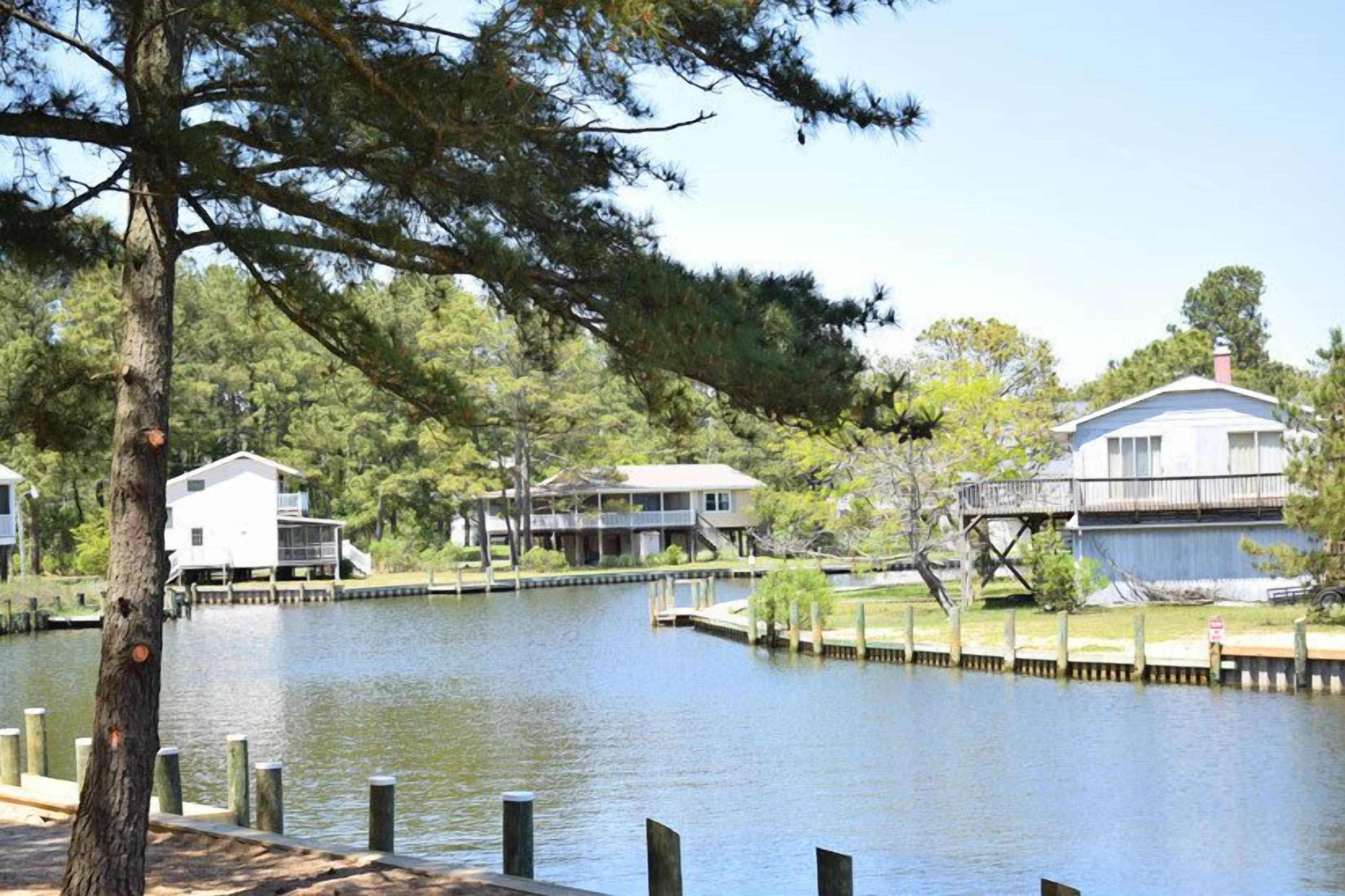 A lakeside property with multiple houses connected by docks.