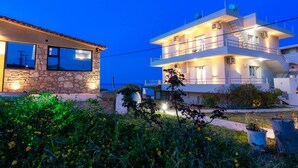 A two-story building with a stone facade and a balcony. - Georgia Apartments (Zakynthos)