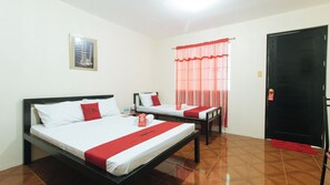 A hotel room with two beds, a door, a window with curtains, and a framed picture on the wall. - Reddoorz @ FDB Homes Nueva Ecija (San Jose City)