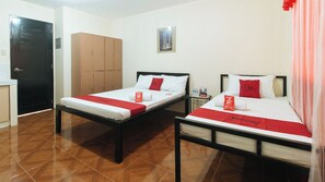 Two single beds with red accents, a wooden wardrobe, and a framed picture on the wall. - Reddoorz @ FDB Homes Nueva Ecija (San Jose City)