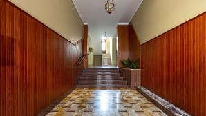A hallway with wooden paneling and a marble floor leading to a staircase. - 2150 Casa Mandù (Manduria)