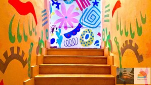 A staircase with colorful abstract wall art. - Happy Land Hotel (Dahab)