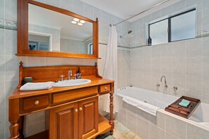 Bathtub, hair dryer, towels, shampoo