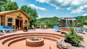 A wooden building labeled "Fitness" with outdoor seating and a fire pit.