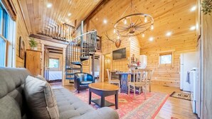 A cozy log cabin interior with a living room, dining area, and kitchen. - Elk Hotspot w/ Views, Deck & Game Room (Estes Park)